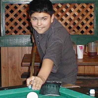 Charles_playing_pool Lee Webster's son Charles, taking a pool shot. A minor in a bar? It's legal if you get away with it. Scanned picture, not sure of the date.