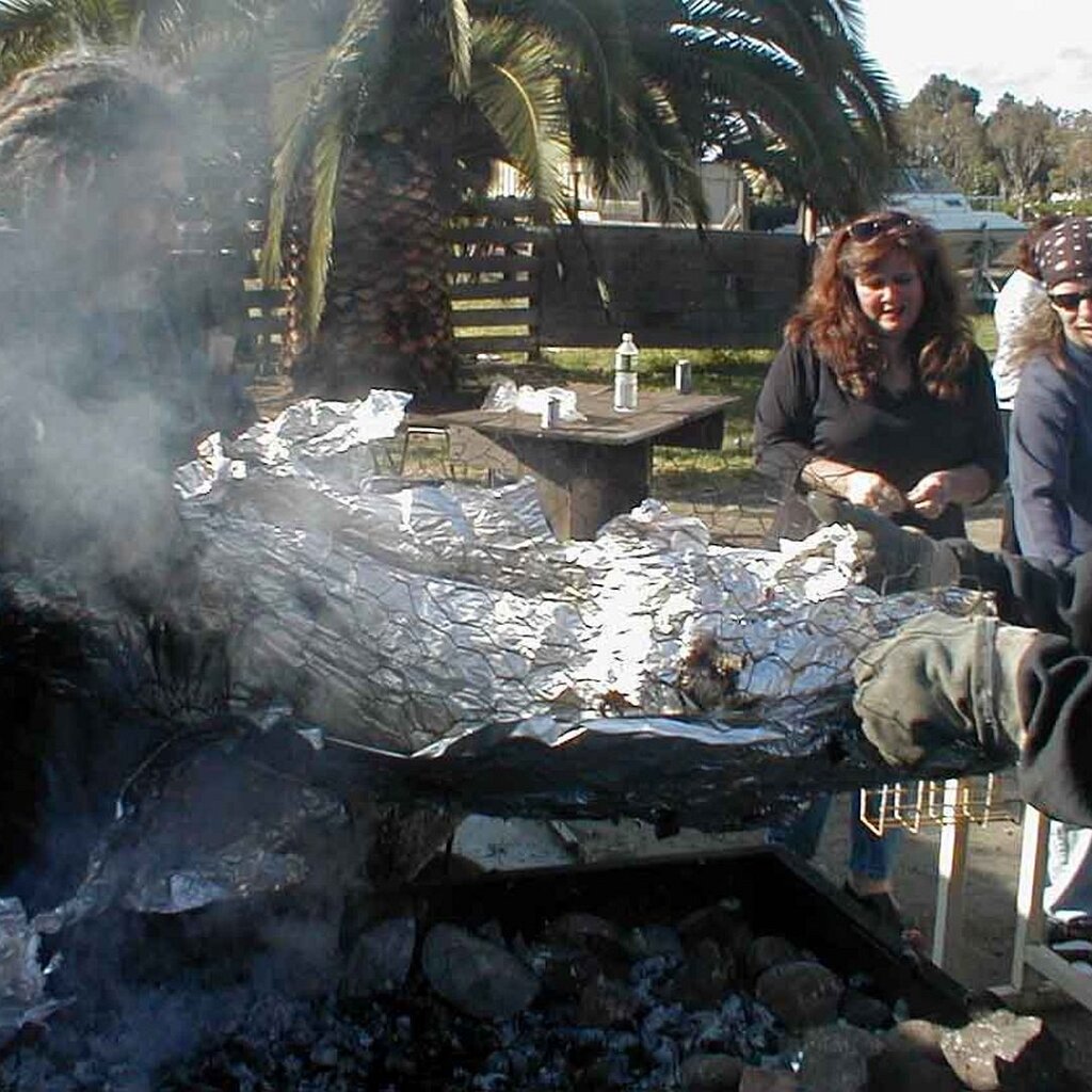 Charlie_Jackson_Halloween_1999-10-28x16-00-00 Etene Fau, Cheri Huerta, Lonnie, and Sam Albert supervise the pig roast at Charlie Jackson's Ferguson house in Mountain View CA, October 28th, 1999.