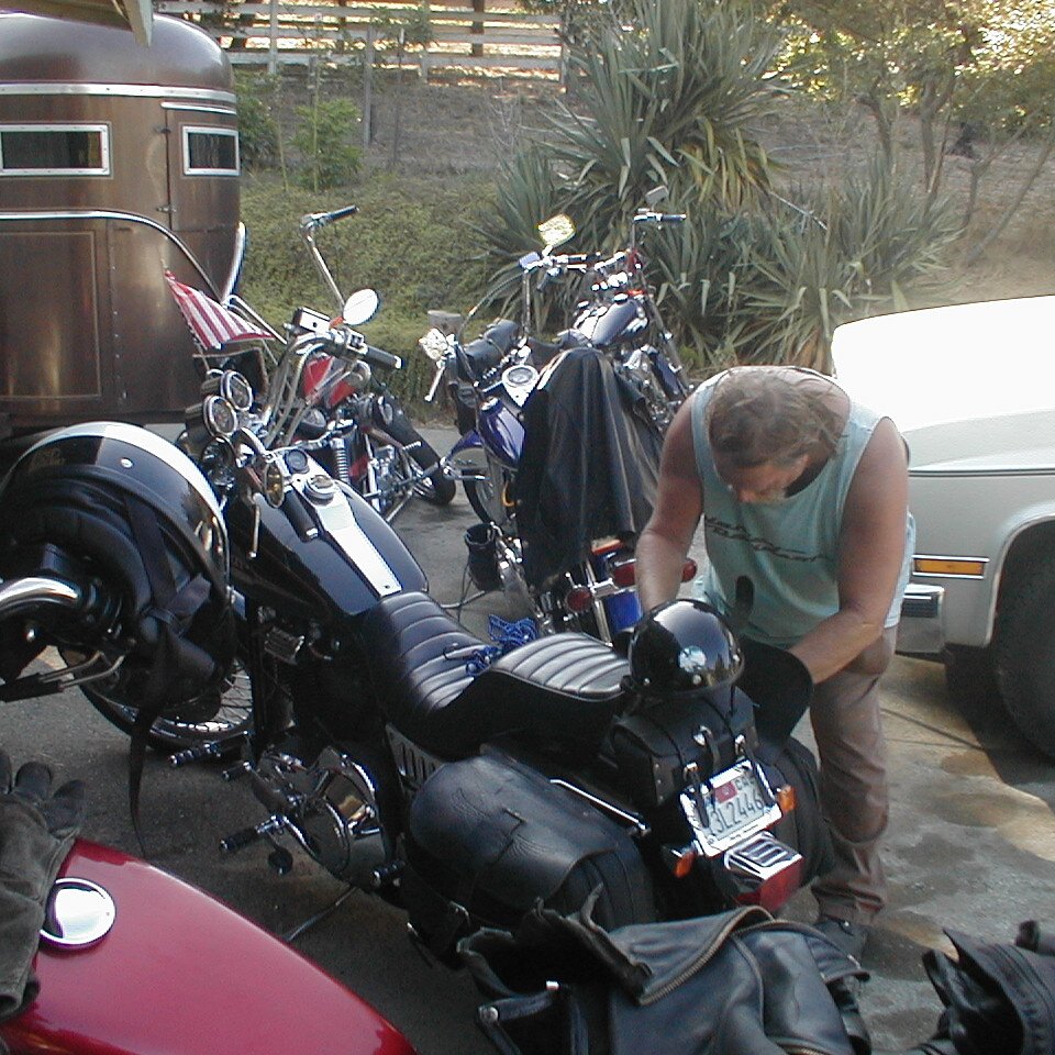 2000-07-01x16-43_Charlie_bag Charlie Jackson getting something out of the saddlebag on his Harley.